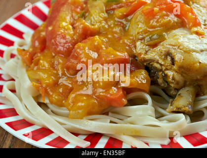 Chicken paprikash - Traditional hungarian chicken cooked in paprika and cream sauce. Served  noodles. Stock Photo