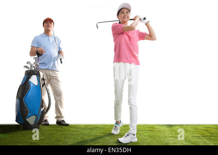 A middle-aged couple playing golf Stock Photo