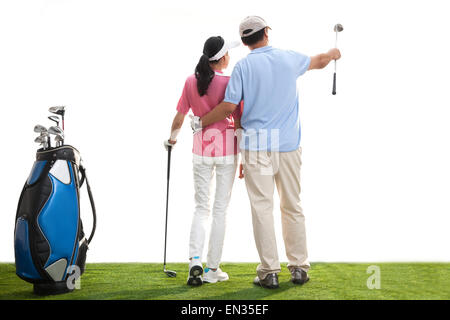 A middle-aged couple playing golf Stock Photo