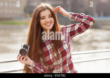 Portrait of a young woman with photo camera Stock Photo