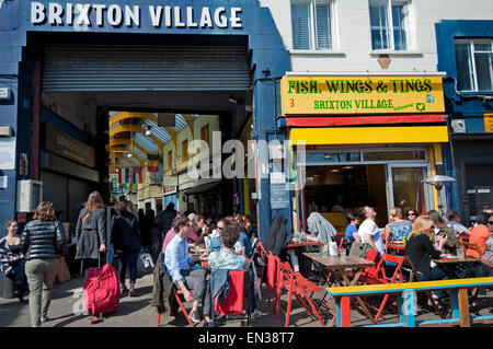 The gentrification of Brixton in the Brixton Village Granville arcade  indoor market Stock Photo