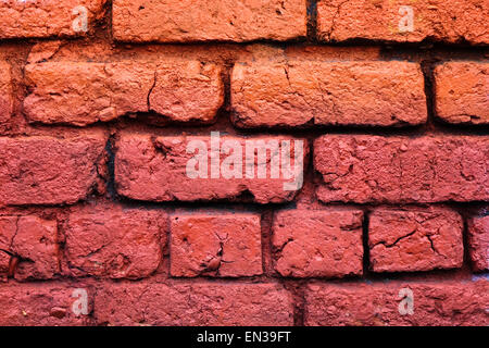Brick wall painted shades of orange . Stock Photo