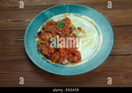 New Orleans Grillades and Grits -  medallions of various meats, conventionally beef, veal and pork. breakfast or brunch over gri Stock Photo