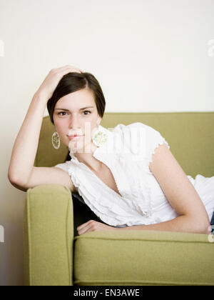 woman lying on a sofa Stock Photo