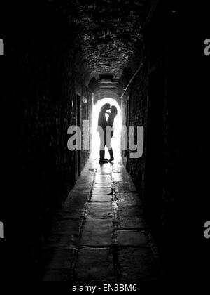 Italy, Venice, Young couple kissing in archway Stock Photo