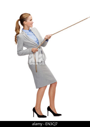 smiling businesswoman pulling rope Stock Photo
