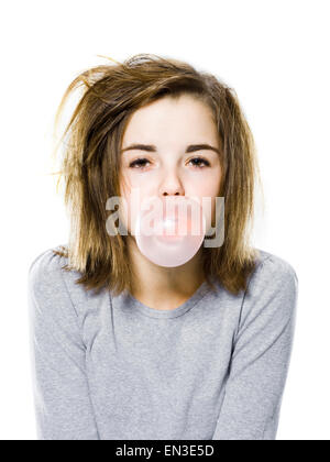 girl with a messy appearance popping a bubble gum bubble Stock Photo