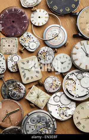Clockwork spare parts. Metal gear, cogwheels, dial. Stock Photo