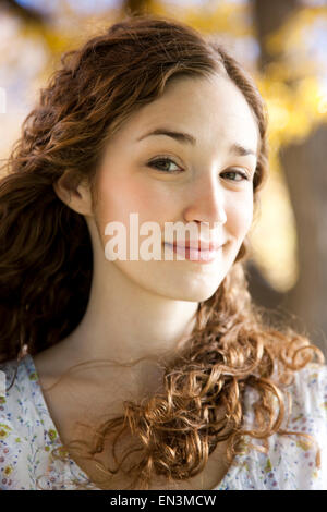 Portrait of young woman standing in Autumn forest Stock Photo