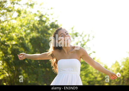 USA, Utah, Lehi, teenage girl (16-17) wearing white dress outdoors