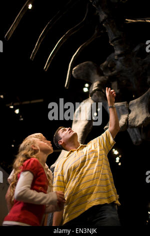 USA, Utah, Lehi, father looking at dinosaur with children (8-11) in museum Stock Photo