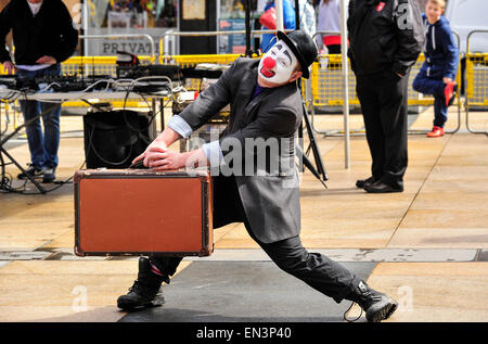 Clown with white painted face and red nose wearing a hat in the Stock ...