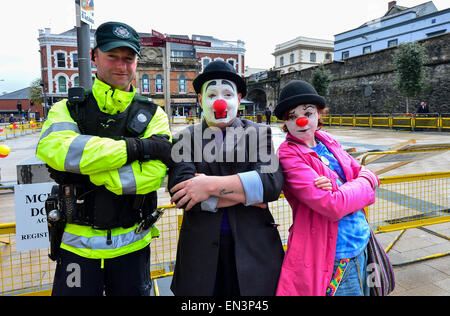 PSNI constable posing with two clowns, at a charity event in the Guildhall Square, Derry, Londonderry. Stock Photo