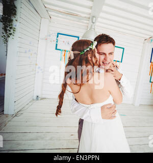 Happy young wedding couple dancing. Bride kissing groom. Instagram vintage effect. Stock Photo