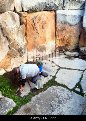 Man working in the The archaeological complex of Tarxien Temples - Malta Stock Photo
