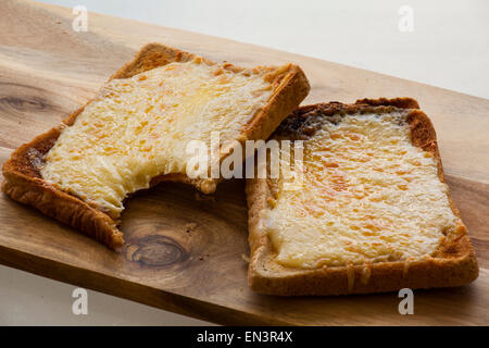 Cheese on toast with a bite taken out of it. Stock Photo