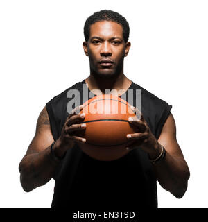 Portrait of male basketball player holding ball Stock Photo