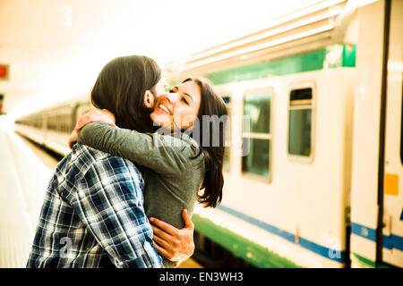 Italy, Venice, Young couple embracing on railway station Stock Photo