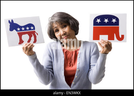 woman holding up political party signs Stock Photo