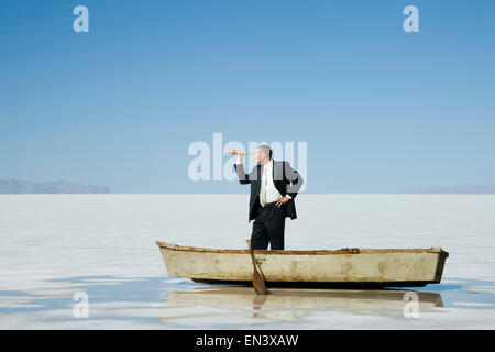 man in a row boat in the middle of nowhere Stock Photo