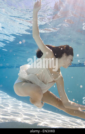 USA, Utah, Orem, Young woman in pool ballet dancing Stock Photo