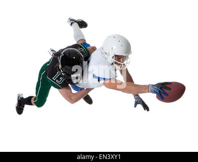 Two male players of American football fighting for ball, studio shot Stock Photo