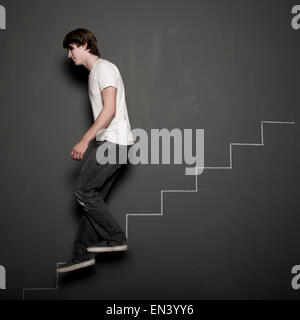 man climbing chalk stairs Stock Photo