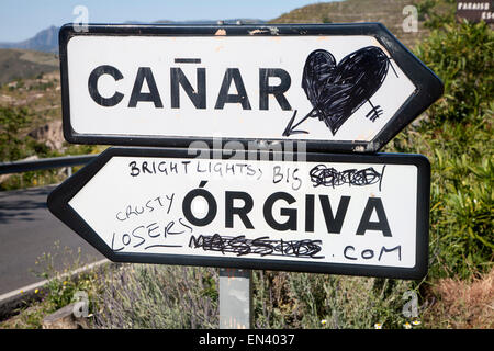 Graffiti on road signs for Orgiva and Canar, Alpujarra area, Granada province, Spain Stock Photo