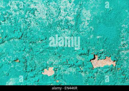 Old bright turquoise grunge material. Peeling paint and rust stains. Stock Photo
