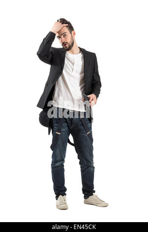 Young fashionable man running fingers through hair. Full body length portrait isolated over white background Stock Photo