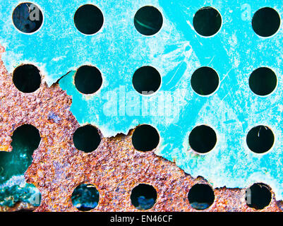 A fenestrated blue metal sheet with rust corrosion Stock Photo