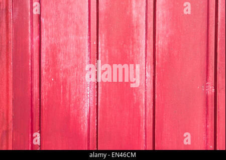 A wooden surface painted red with mild weathering, as a background image Stock Photo