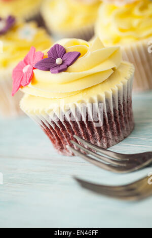 Yellow cupcakes on a wooden board Stock Photo