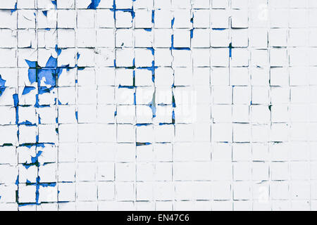 Peeling paint on a wall of tiles as a background image Stock Photo