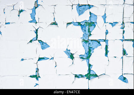 Peeling paint on a wall of tiles as a background image Stock Photo