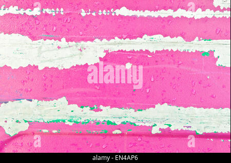 Peeling pink paint on a metal surface as an abstract Stock Photo