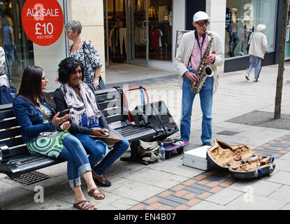 Man playing saxophone in street Stock Photo