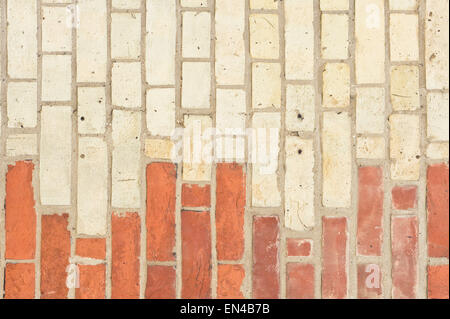 Orange and beige bricks in a wall as a background Stock Photo
