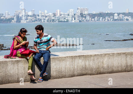 Mumbai India,Churchgate,Marine Drive,Back Bay,Arabian Sea,man men male,woman female women,couple,romantic,Malabar Hill skyline,buildings,India15022606 Stock Photo