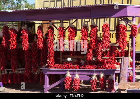 Colorful display of red chili pepper bundles in a purple stand in Santa Fe, New Mexico Stock Photo