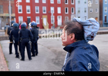 Baltimore, USA. 27th Apr, 2015. A man is injured on the head by looters in Baltimore, Maryland, the United States, April 27, 2015. Maryland governor Larry Hogan Monday evening declared a state of emergency and activated the National Guard to address the escalating violence and unrest in Baltimore City following the funeral of a 25-year-old black man who died after he was injured in police custody. Credit:  Yin Bogu/Xinhua/Alamy Live News Stock Photo