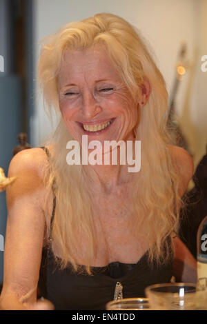 An attractive mature woman at a New Year's Eve family dinner party; in Brussels, Belgium. Stock Photo