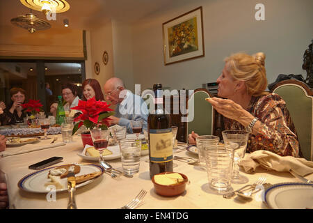 Relatives at a New Year's Eve family dinner party, with a mixed age range; in Brussels, Belgium. Stock Photo