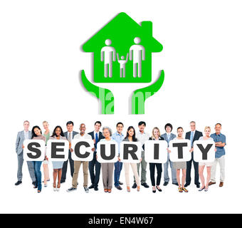 Multi-Ethnic Group Of Diverse People Holding Letters That Form Security And A Picture Of Family House Above Stock Photo