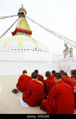 praying monks in Boudhanath stupa temple, Kathmandu, Nepal Stock Photo