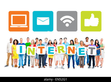 Multi-Ethnic Group Of People Holding Alphabet To Form Internet And Internet Themed Images Above Stock Photo
