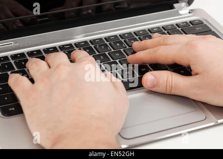 hands typing on laptop top view Stock Photo