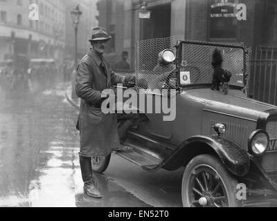 Special constable seen here with his patrol car in the City of London on the 9th day of the General Strike. The barbed wire across the windscreen is to protect the driver from attacks from strikers.  The national dispute came about after negotiations betw Stock Photo