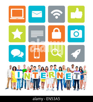 Multiethnic Group Of People Holding Alphabet To Form Internet And Related Images Above Stock Photo