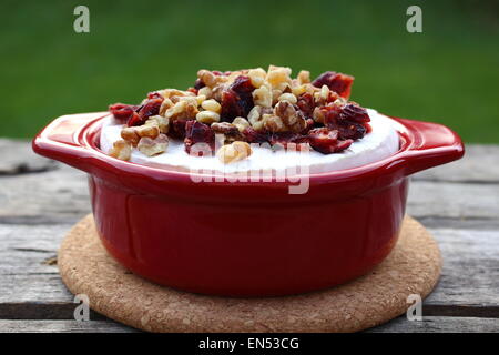Brie Cranberry and walnuts in a pot ready for the oven on old wooden planks Stock Photo